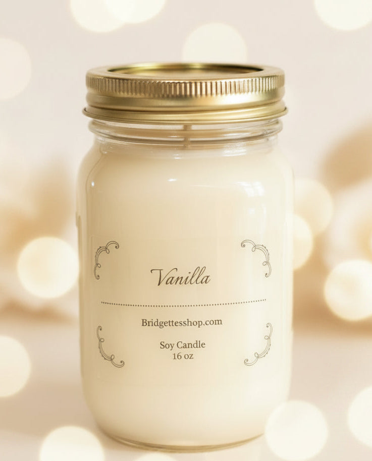 Vanilla candle in a mason jar with a gold lid on a blurred lights background