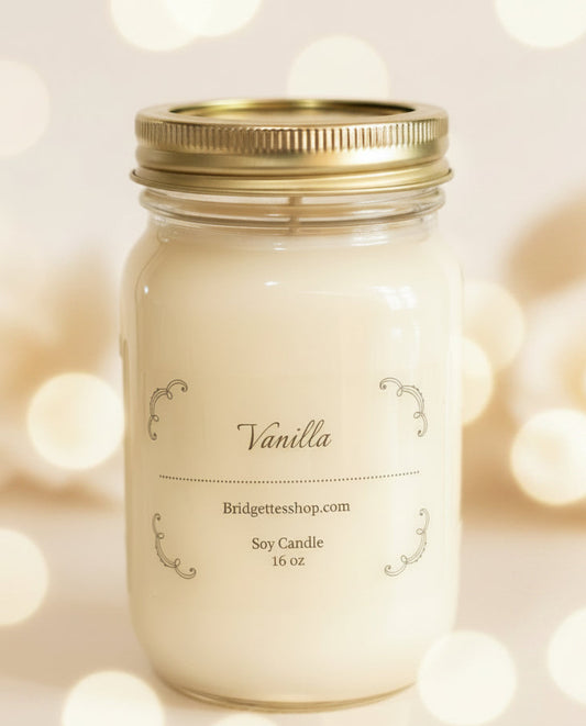 Vanilla candle in a mason jar with a gold lid on a blurred lights background