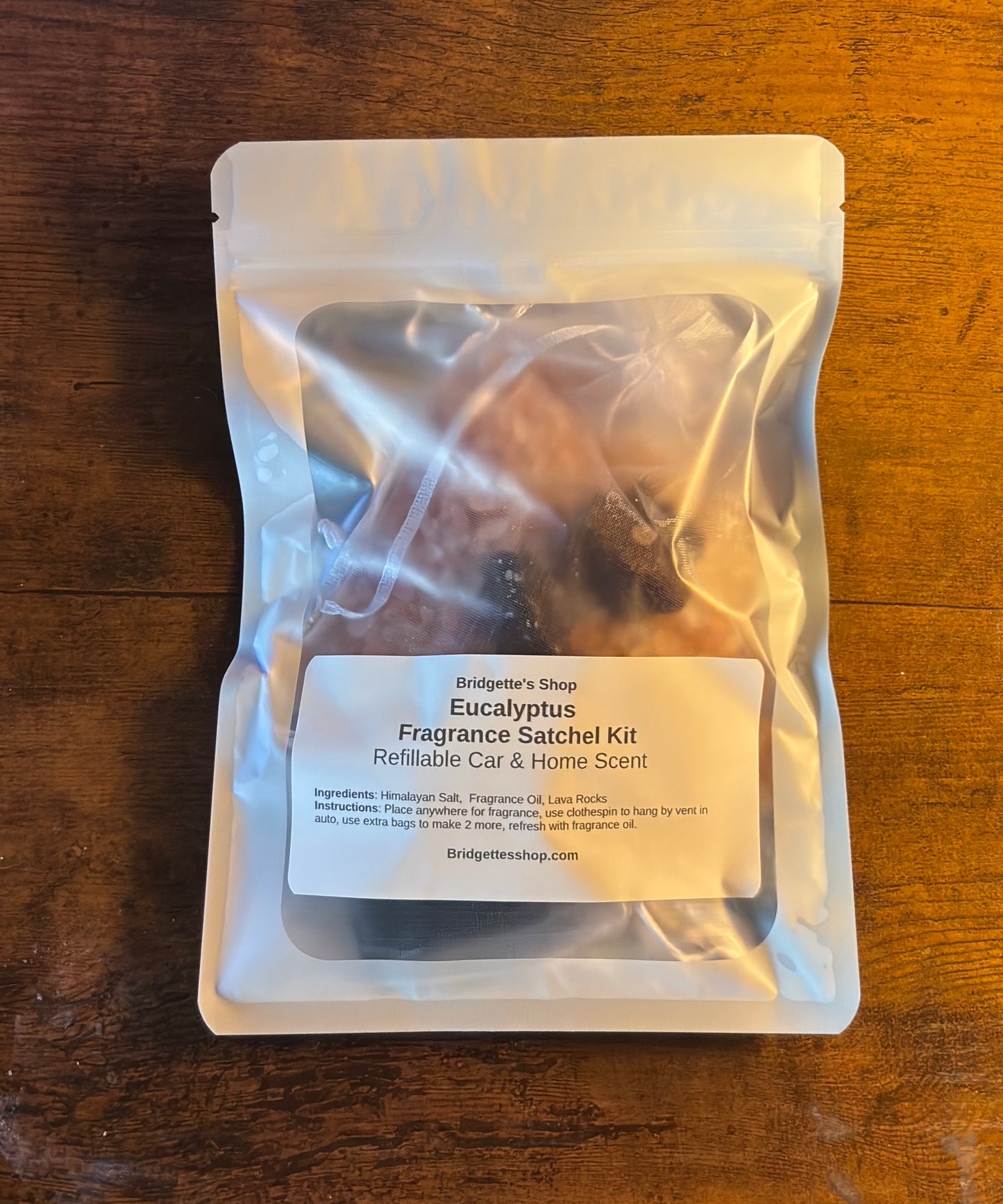 Eucalyptus fragrance satchel kit packaging on a wooden surface
