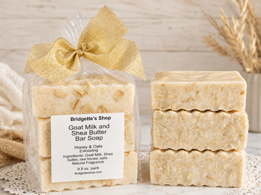 Goat milk and shea butter bar soap with a gold bow and Bridgette's Shop label.