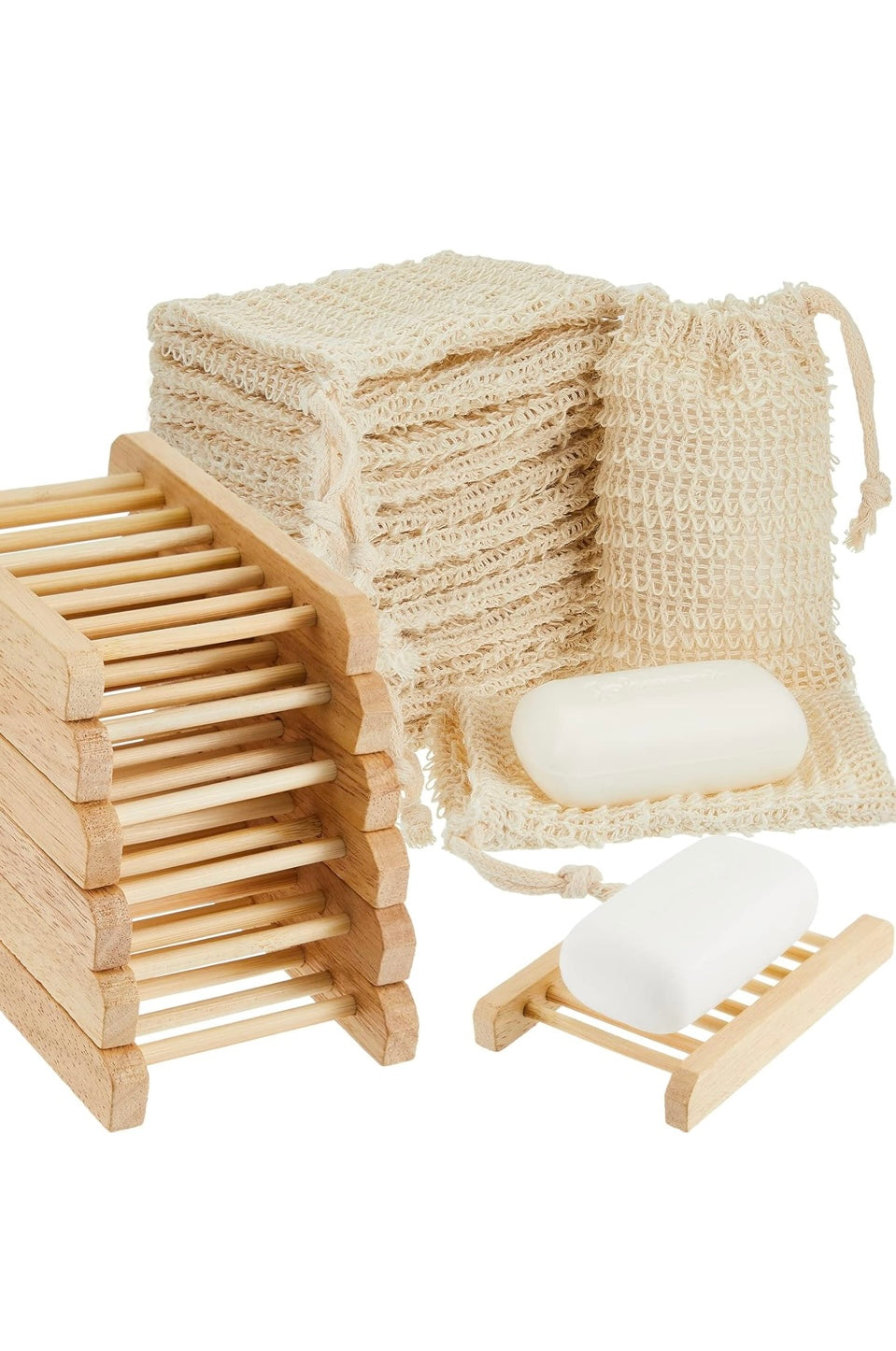 Wooden soap dish with stacked soap bars and a woven soap bag on a white background