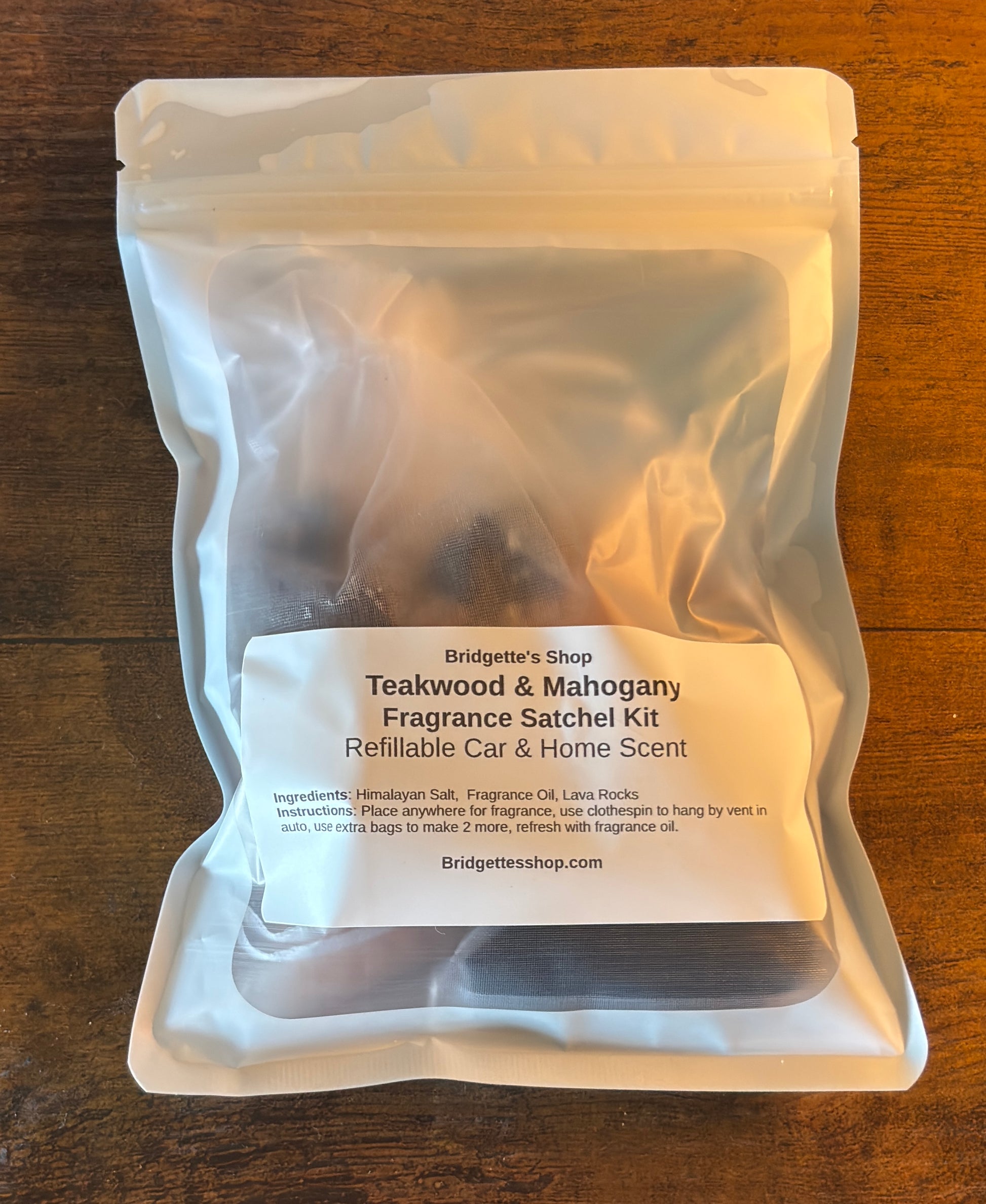 Teakwood & Mahogany fragrance satchel kit packaging on a wooden surface