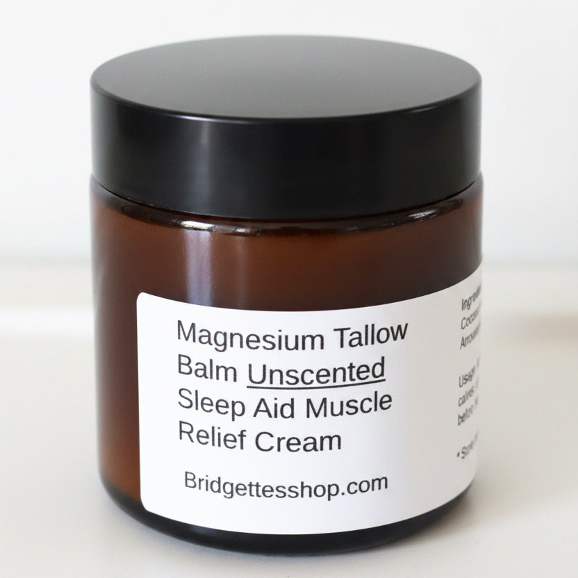 Jar of magnesium tallow balm with a black lid on a white surface