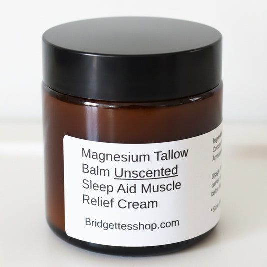 Jar of magnesium tallow balm with a black lid on a white surface