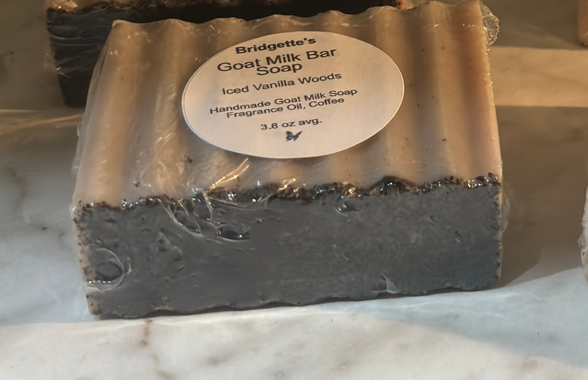 Bar of Bridgette's Goat Milk Bar Soap with a label on a marble surface