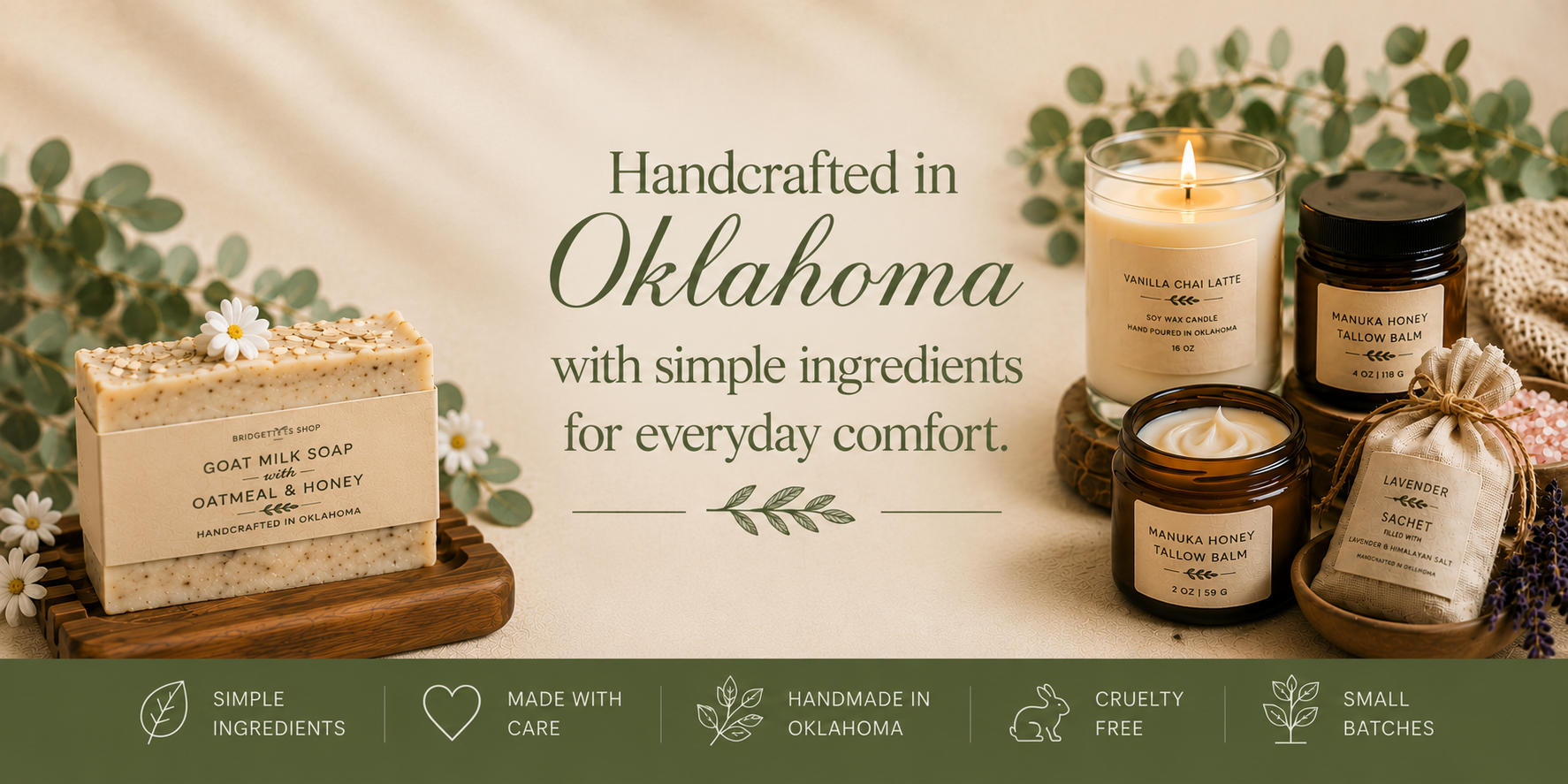 A styled product banner for handmade skincare and candles in Oklahoma. On the left is a bar of goat milk soap on a wooden tray, and on the right are three lit candles in glass jars and a small fabric bag, all with matching labels.