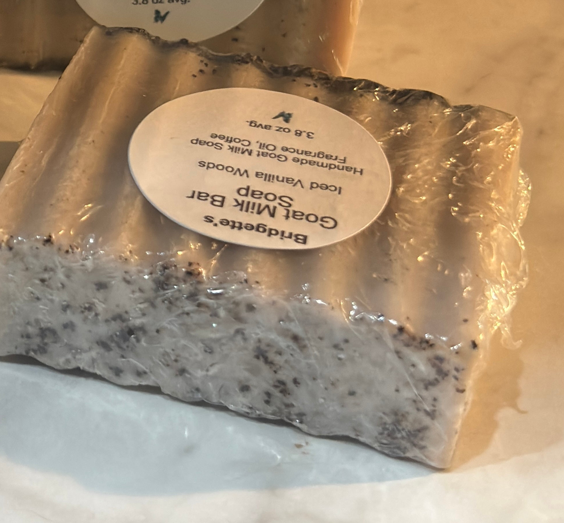 Goat milk soap bar with a label on a white background
