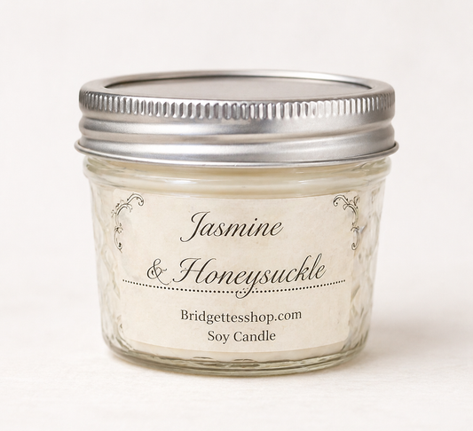 Jar of Jasmine & Honeysuckle candle with silver lid on a white background