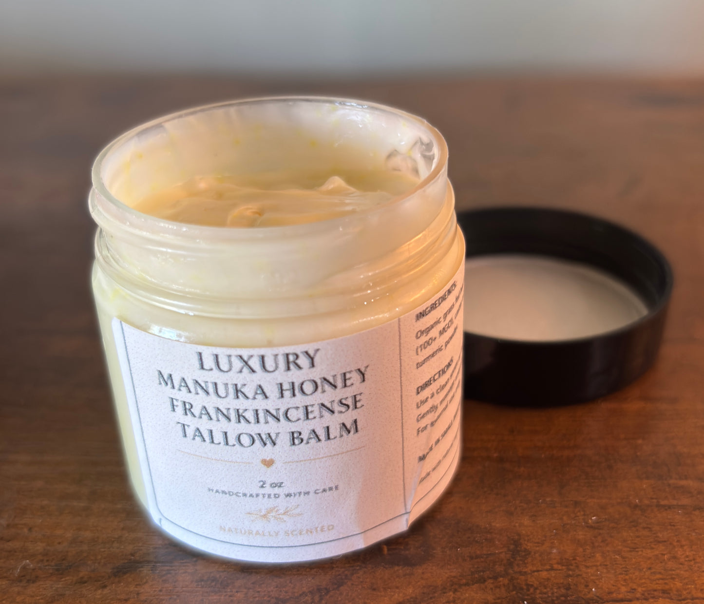 Jar of Luxury Manuka Honey Frankincense Tallow Balm on a wooden surface