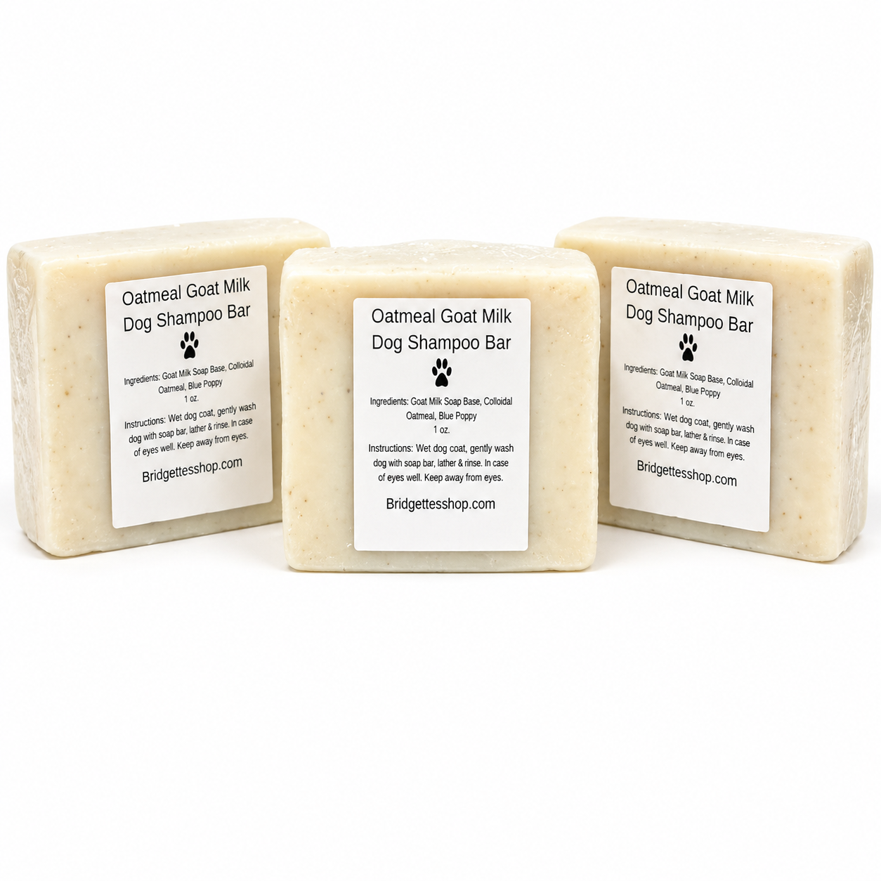 Three Oatmeal Goat Milk Dog Shampoo Bars with labels on a white background